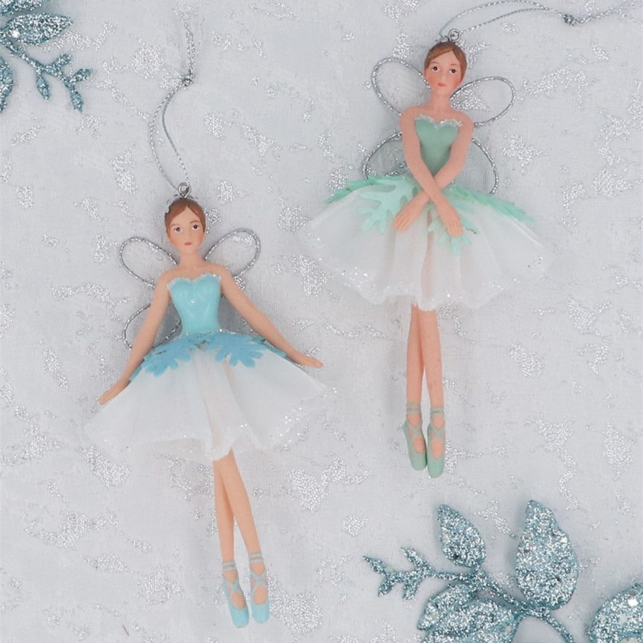 A beautiful pair of blue, green and white hanging fairies. These fairies will definitely add a special festive touch to your tree.