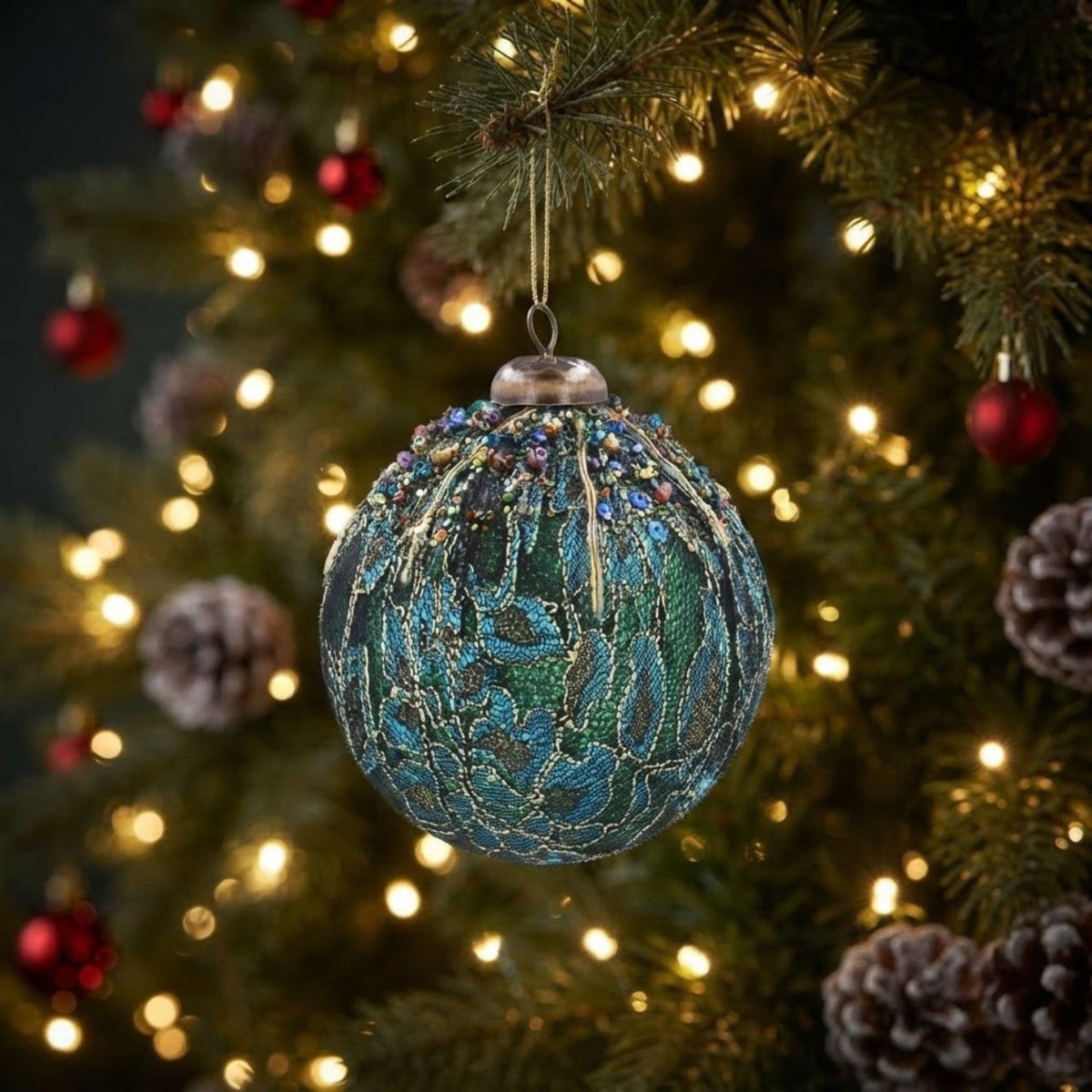 Brighten up the holiday season with Gisela Graham's Blue & Teal Fabric Flowers Beaded Christmas Bauble! This delightful festive item is crafted with intricately beaded fabrics and pretty petal shaped cloth flowers for an elegant look.
