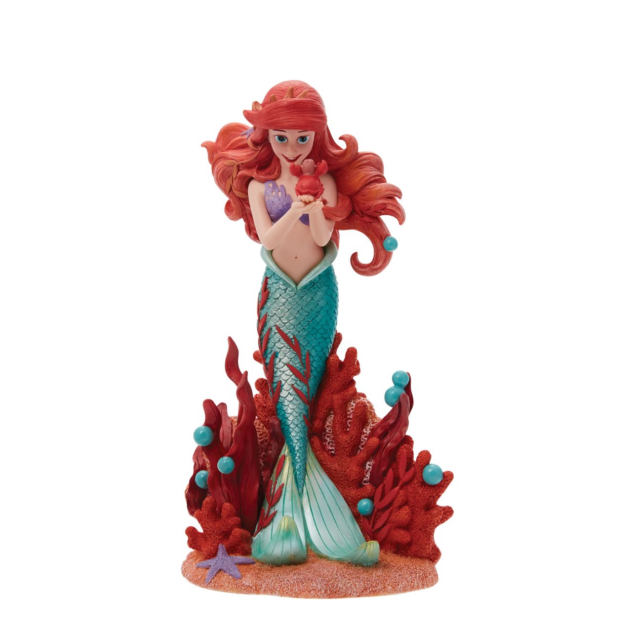 Ariel joins the Disney Showcase Botanical collection in honour of the film's 35th Anniversary featuring sea florals and coral (which is the 35th Anniversary gift). Ariel holds a small Sabastian in her delicate hands as she listens intently to his story. A vibrant base of coral, sand and rising bubbles encapsulates the underwater princess.