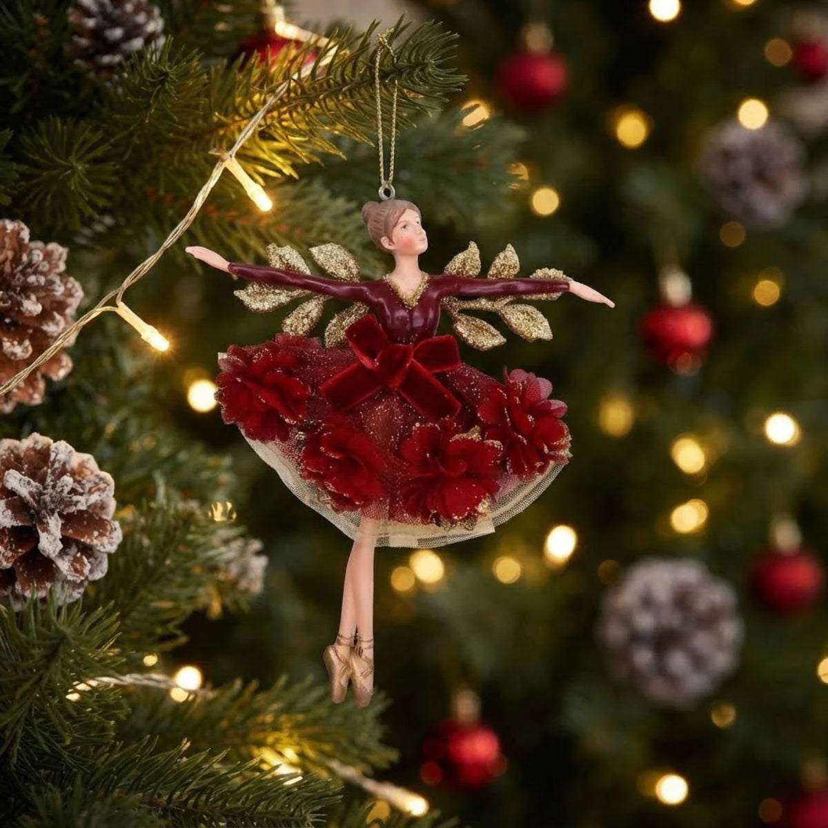 Bring festive elegance to your tree with this enchanting Gisela Graham Burgundy Floribunda Fairy Hanging Ornament. Crafted in rich burgundy tones, this delicate fairy design captures the magic of the season with its intricate floral details and graceful silhouette.
