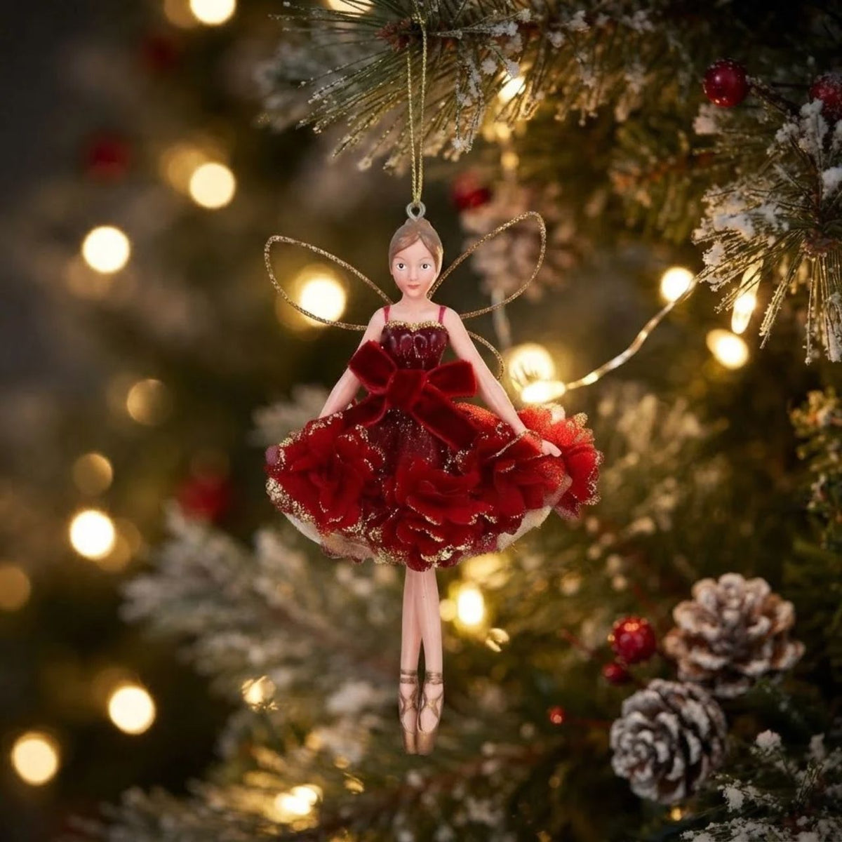 Bring festive elegance to your tree with this enchanting Gisela Graham Burgundy Floribunda Fairy Hanging Ornament. Crafted in rich burgundy tones, this delicate fairy design captures the magic of the season with its intricate floral details and graceful silhouette.