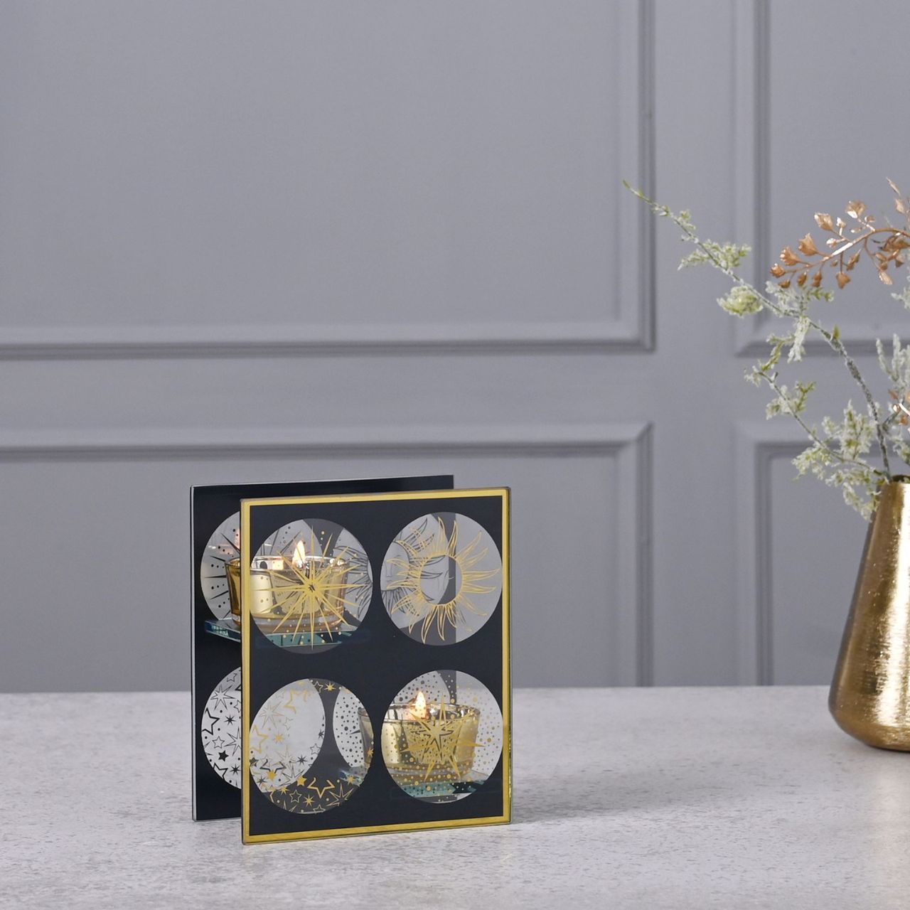 Celestial Double Tealight Holder  A celestial single glass tea light holder by THE SEASONAL GIFT CO.  This celestial tea light holder takes inspiration from the stars as it shines brightly for all to admire.