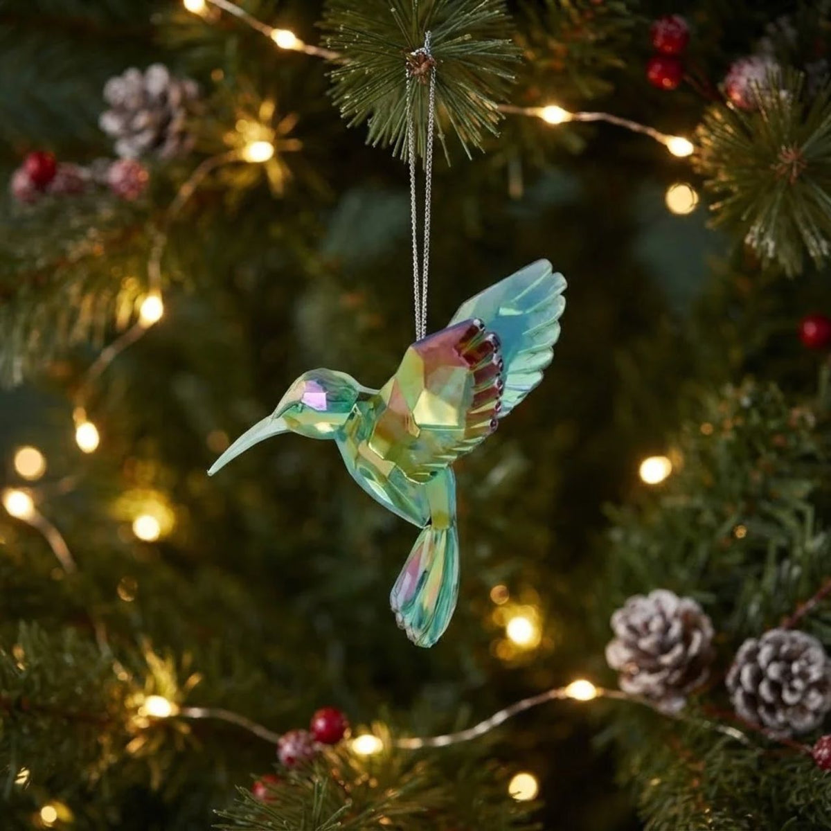 Bring a touch of nature-inspired elegance to your holiday décor with this charming acrylic hummingbird hanging ornament. Measuring 4.25" in height, this delicate piece captures the grace and vibrancy of these beloved birds.
