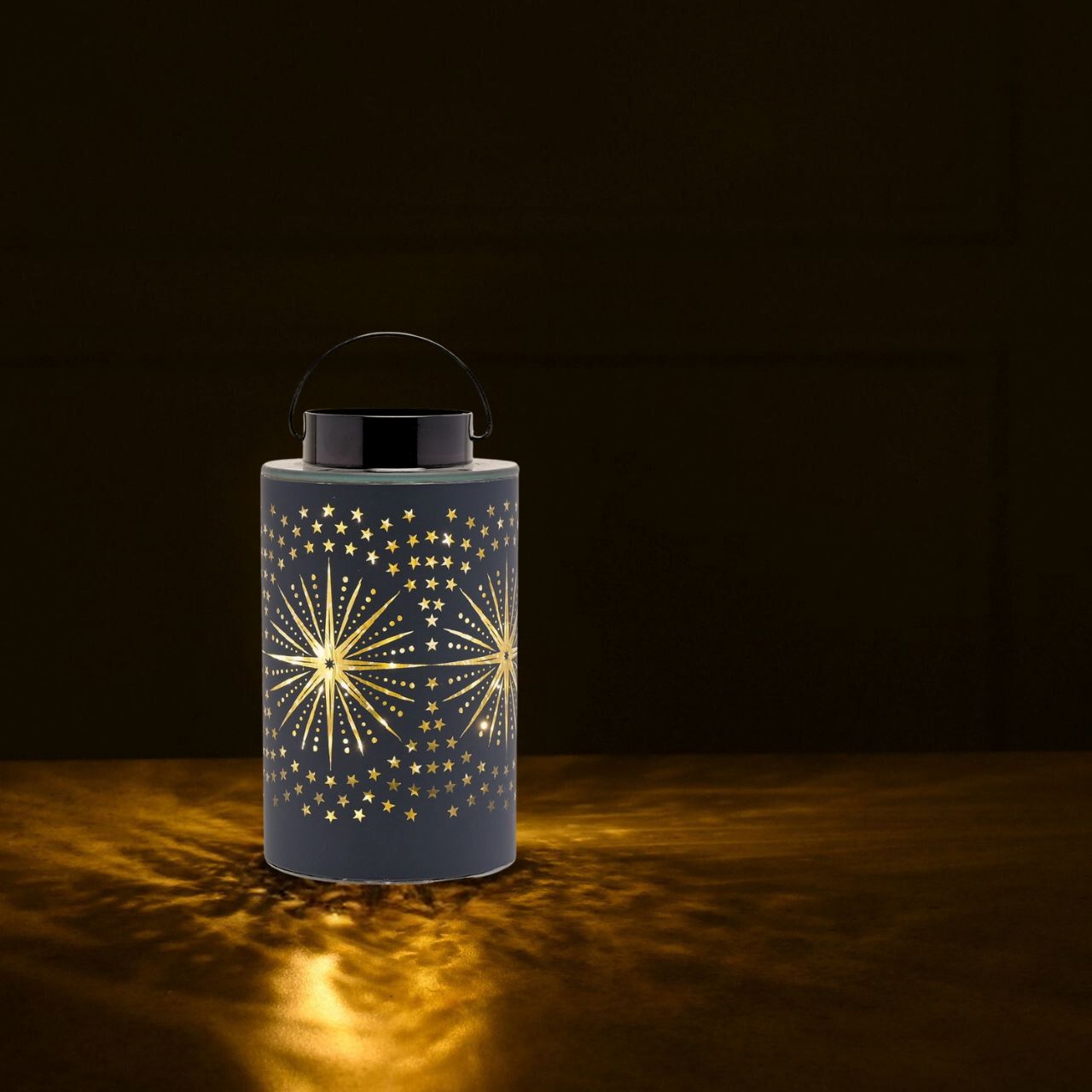 This celestial lantern takes inspiration from the stars when displayed at Christmas time.  The decorative glass lantern showcases a distinctive cut out star design, blue colouring, and complementary handle. Its LED lights fill the lantern with glowing colour.