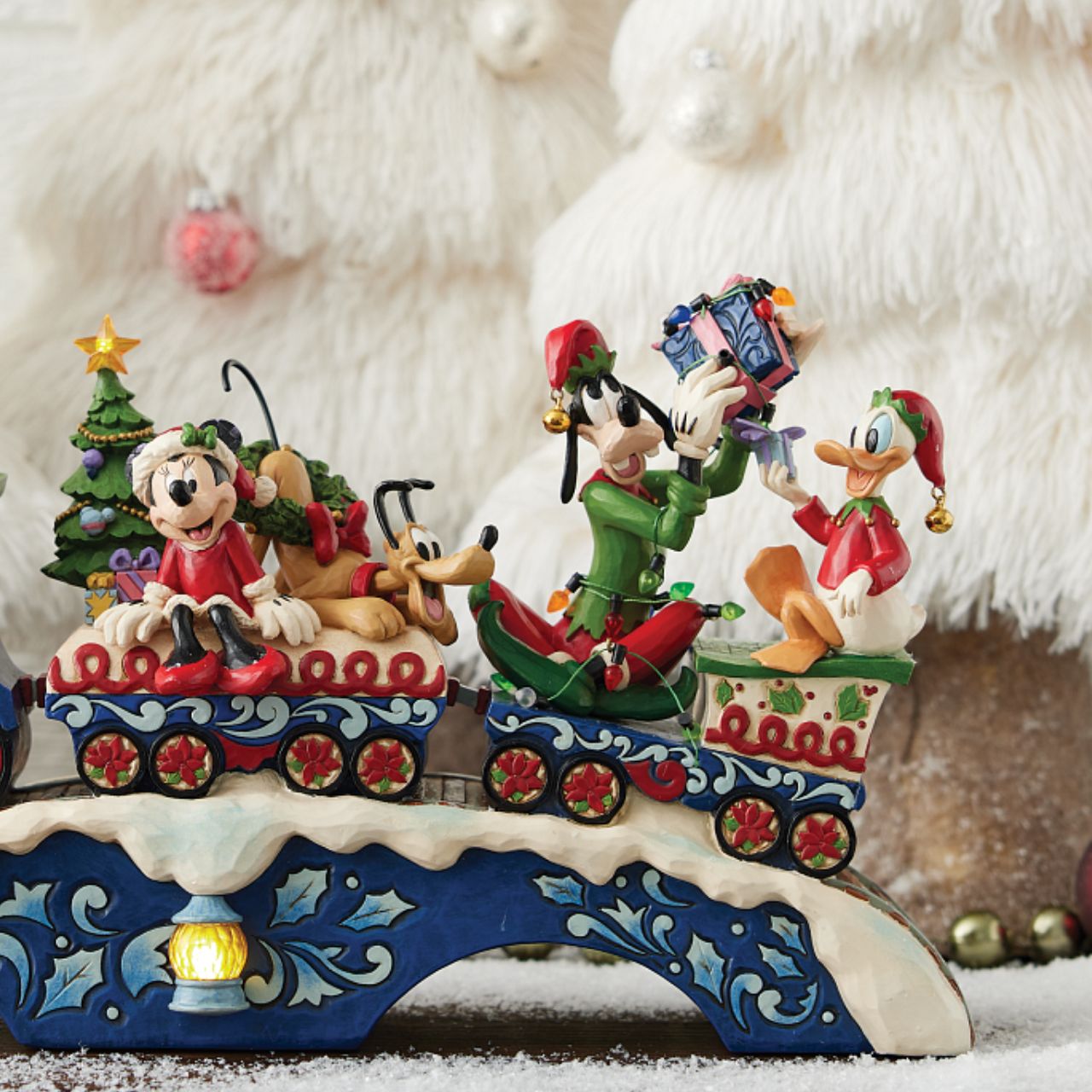 This fantastic Jim Shore Mickey Mouse Express chugs along a snowy track, bringing festive cheer as it lights up and plays eight beloved Christmas tunes. With intricate details, the train showcases Mickey and his friends, trees, gifts, and lights.