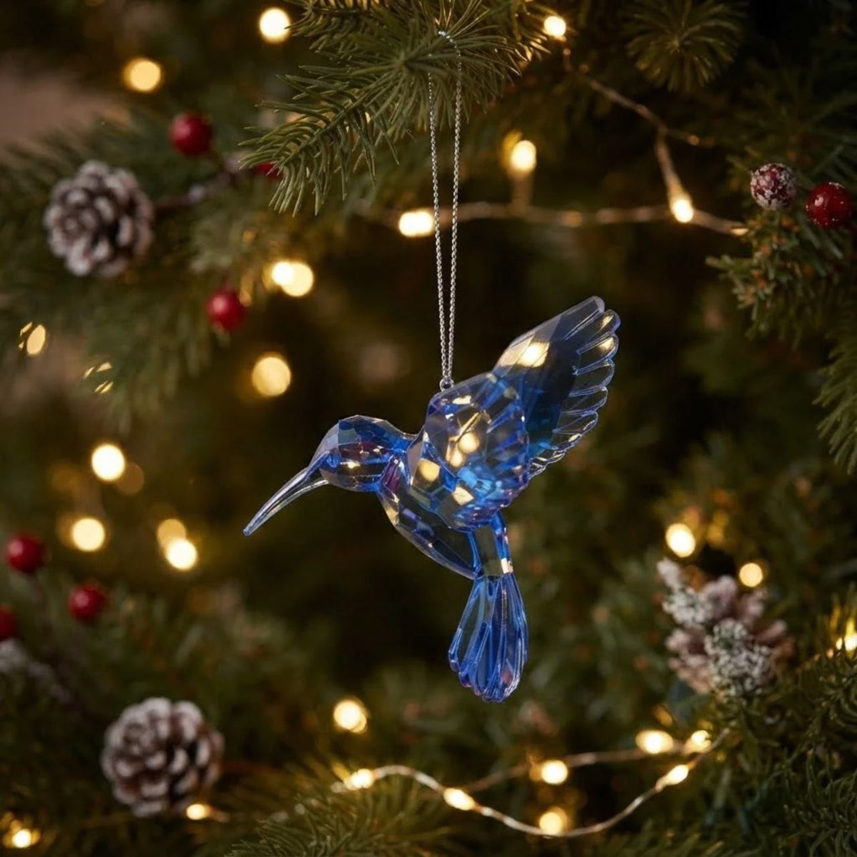 Bring a touch of nature-inspired elegance to your holiday décor with this charming acrylic hummingbird hanging ornament. Measuring 4.25" in height, this delicate piece captures the grace and vibrancy of these beloved birds.