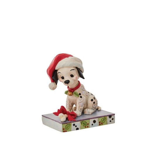 With one hundred and one brothers and sisters, Christmastime is a delight for Lucky. Enjoying the winter in London, Lucky savours a bone while he wears holly and a Santa hat decked out in Jim Shore's intricate detail.