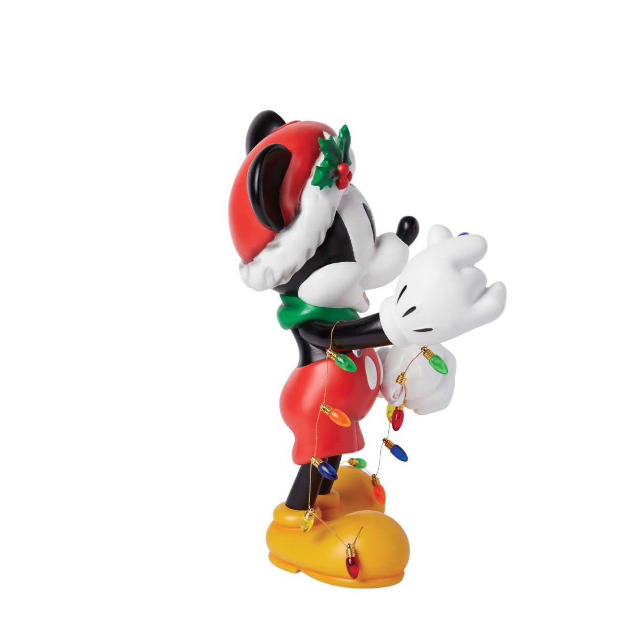 The Holiday Mickey Figurine by Disney Showcase is a fantastic gift for lovers of Disney's iconic mouse. Standing over 30cm tall and dressed in his festive outfit whilst holding a string of Christmas lights, this Mickey figurine is a delightful display piece that will be admired by all those who see it. 