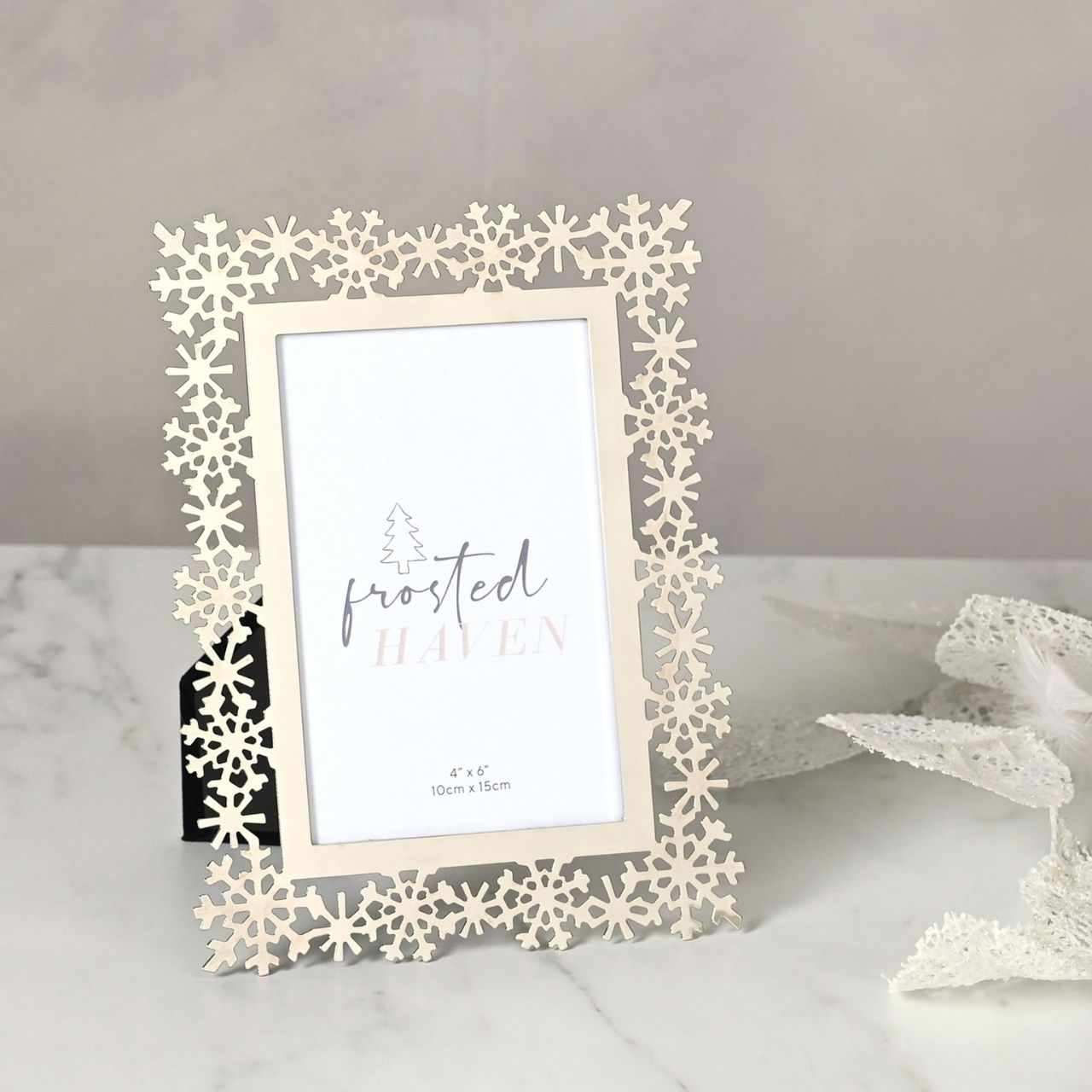 Silverplated Christmas Snowflake Photo Frame 4" x 6"  A silver plated snowflake photo frame.  This glistening frame provides a festive display for photographs of loved ones at Christmas time.