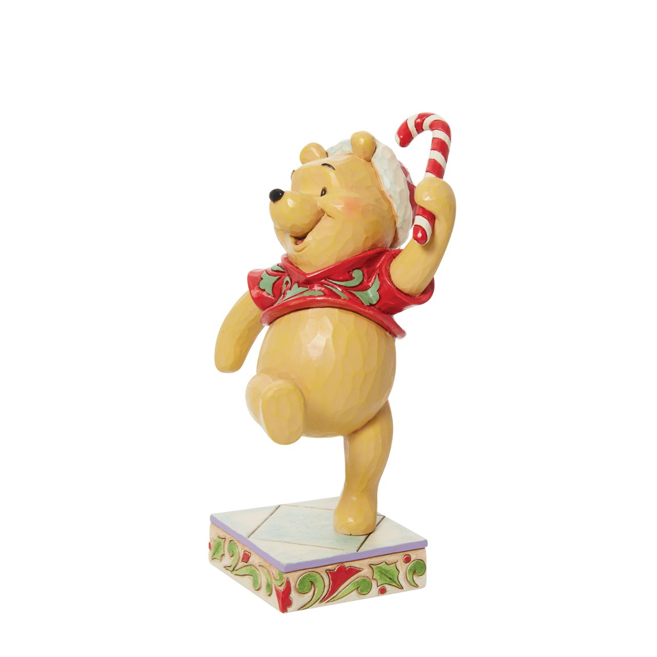 Disney Traditions Christmas Holiday Pooh Figurine  Disney's super cute Winne the Pooh is in the festive mood. This Christmas themed piece has been designed by award winning artist Jim Shore.