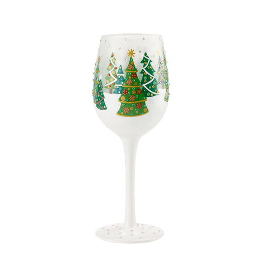 Christmas Trees in the Snow Wine Glass by Lolita  Christmas pines covered in lights and ornaments cover this winter wonderland wine glass. With textured snow and glittering accents, this wine glass is ready for wassail and snowflakes.