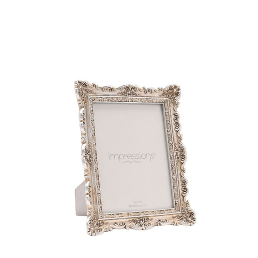 Introduce a touch of elegance to your decor with the Impressions Classical Design Resin Photo Frame 5" x 7". This ornate frame, with "Impressions" artfully printed on the glass surface, offers a stylish backdrop for your cherished memories.