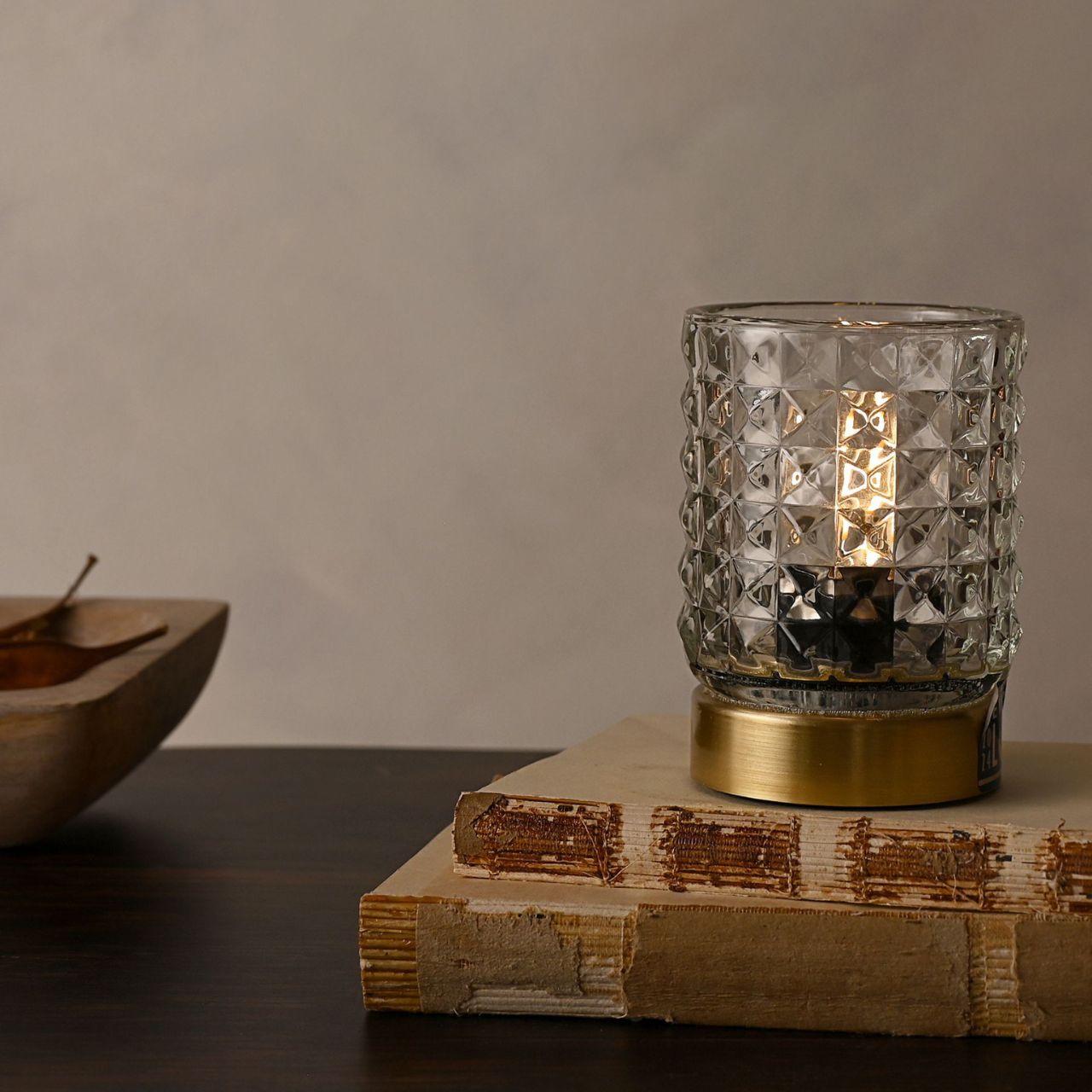 Its textured glass shade casts a soft ripple shadow and will emit a lovely soft glow. Finished on a brushed brass effect base and is operated by an on off switch to the base.