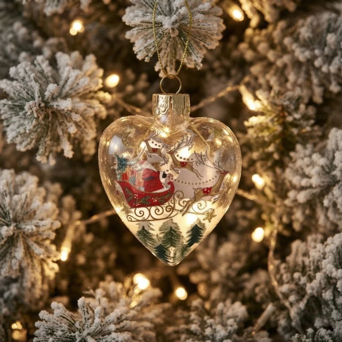 Gisela Graham Bring nostalgic charm to your tree with this elegant heart-shaped glass bauble from Gisela Graham. Choose between a delightful Santa on his sleigh or reindeer design, both beautifully rendered in clear glass for a timeless look.