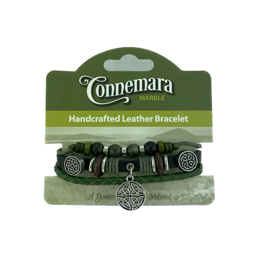 This Connemara Marble Celtic Knot Charm Bracelet combines authentic Irish craftsmanship with natural elegance. Featuring a genuine Connemara marble bead paired with a finely detailed Celtic knot charm, it is strung on durable leather for a comfortable, adjustable fit.