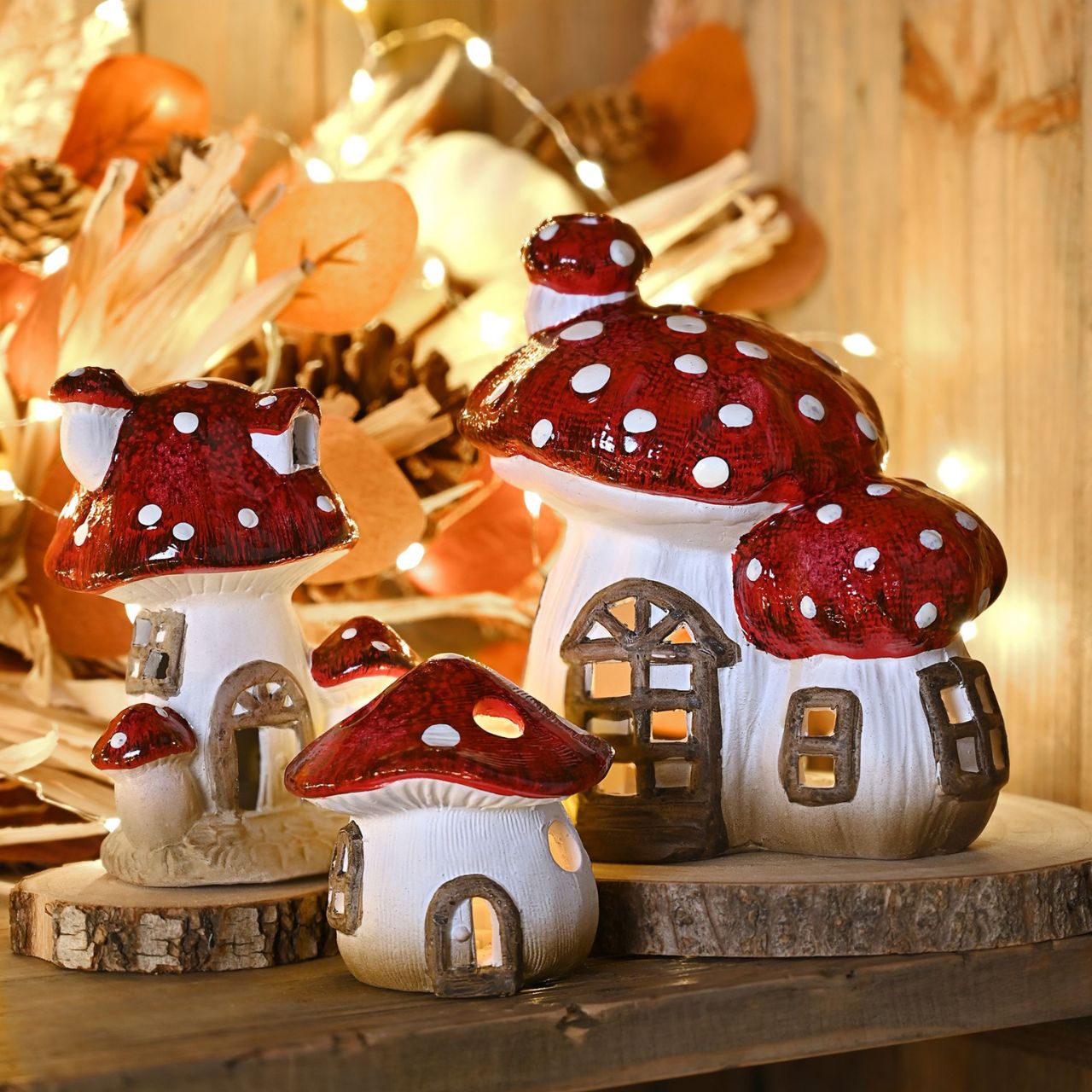 A Country Living Multi Toadstool Cottage with LED Light. This charming decorative piece brings the whimsical spirit of autumn into the home.