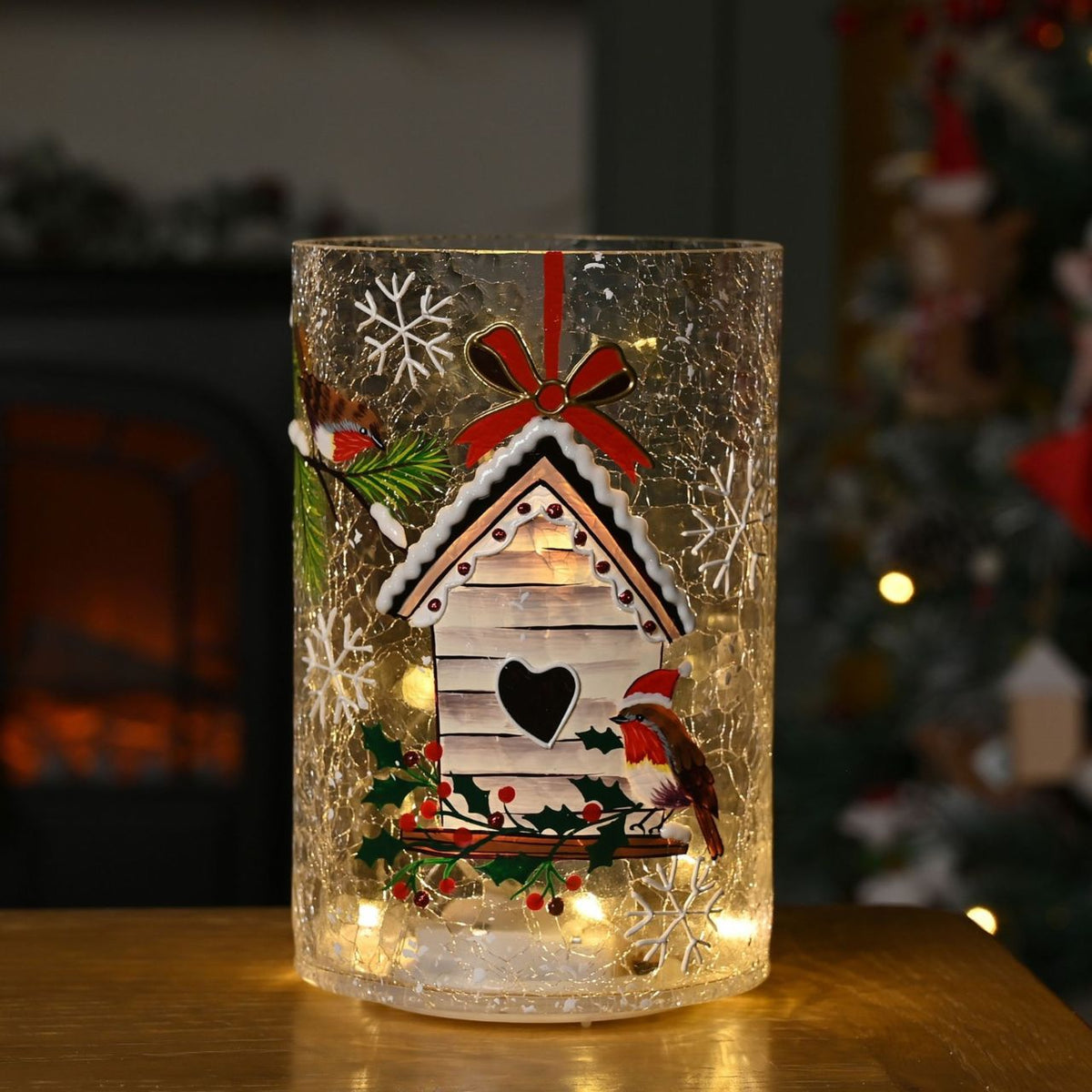 The Crackle Glass Christmas LED Vase with Bird House Design offers a charming centrepiece for festive interiors.