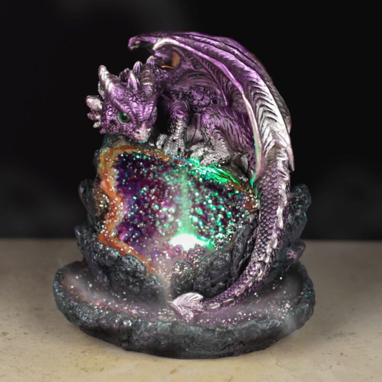 The Crystal Cave Baby Dragon LED Backflow Incense Burner combines artistry and function, featuring a detailed dragon design that enhances any space. Its LED lighting highlights the intricate crystal cave base, creating a captivating visual effect.