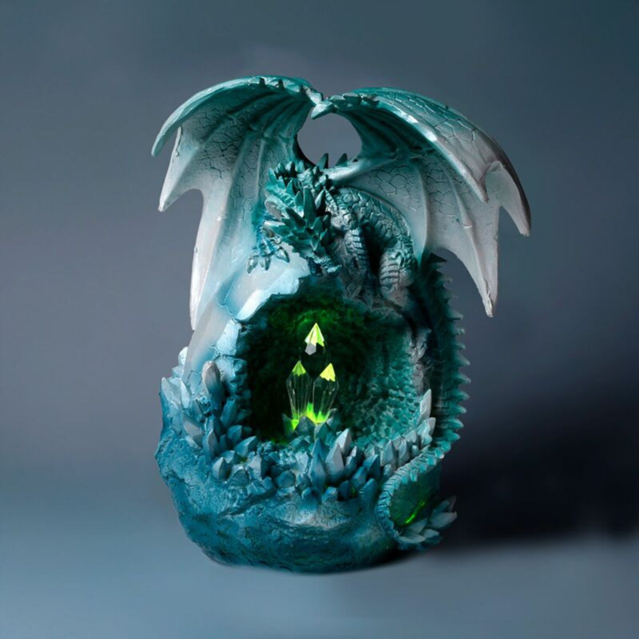 The Dark Legends LED Crystal Ice Cave Dragon is a striking decorative piece that combines intricate crystal detailing with ambient LED lighting. Its icy design captures a mystical essence, making it a captivating centerpiece for any sophisticated space.