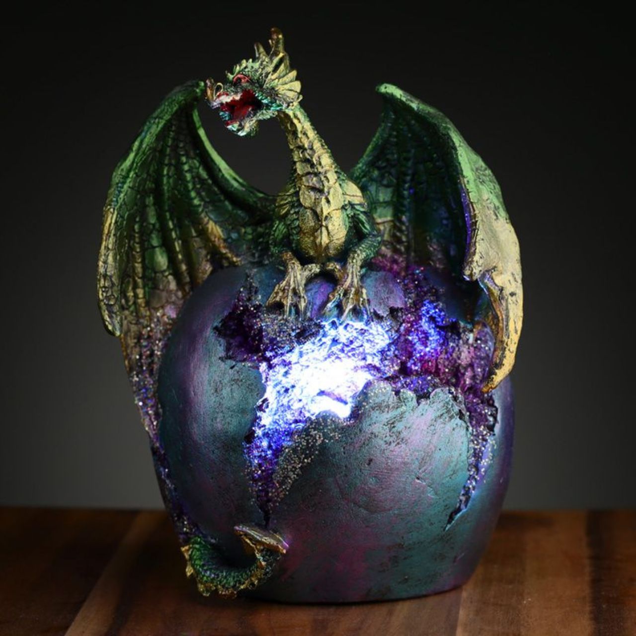Illuminate your space with the mystical beauty of the Dark Legends LED Geode Earth Dragon Egg. This unique piece features a geode design with LED lights, adding an enchanting touch to any room. Let the magic of the Earth Dragon Egg bring a sense of wonder and awe into your home.