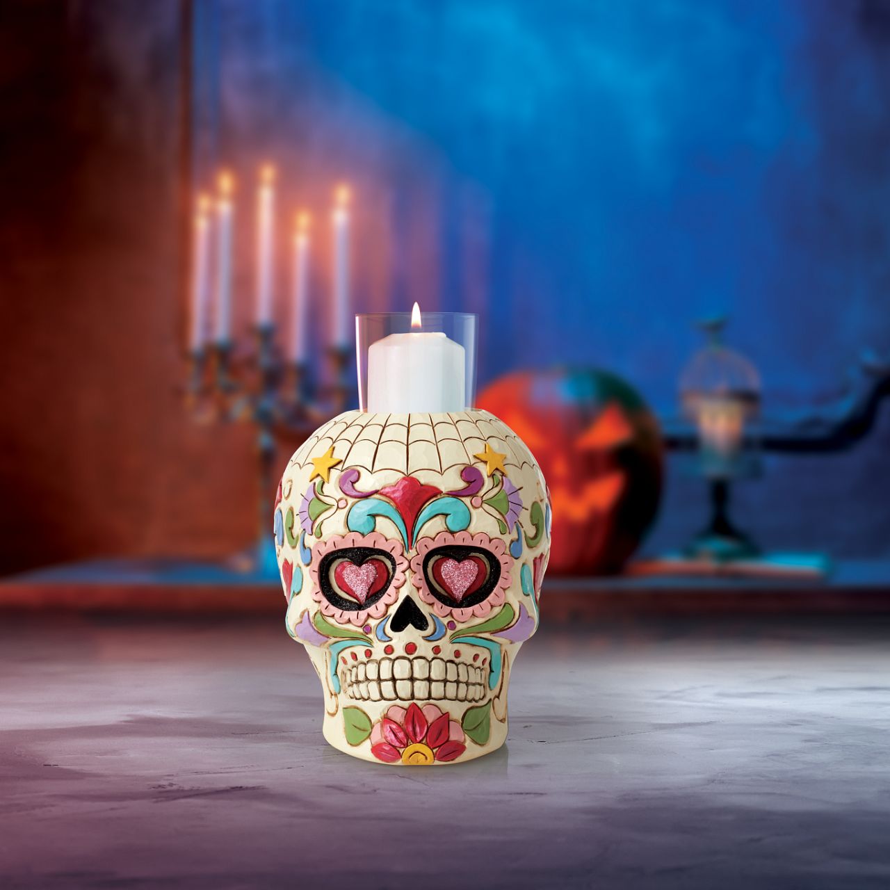 Designed in the iconic style of Jim Shore. This Day of the Dead purple skull candleholder is beautifully decorated with lively Mexican inspired pattern and colour. Modelled after a sugar skull. Hand painted in high quality cast stone. Designed by award-winning artist and sculptor Jim Shore for Heartwood Creek.