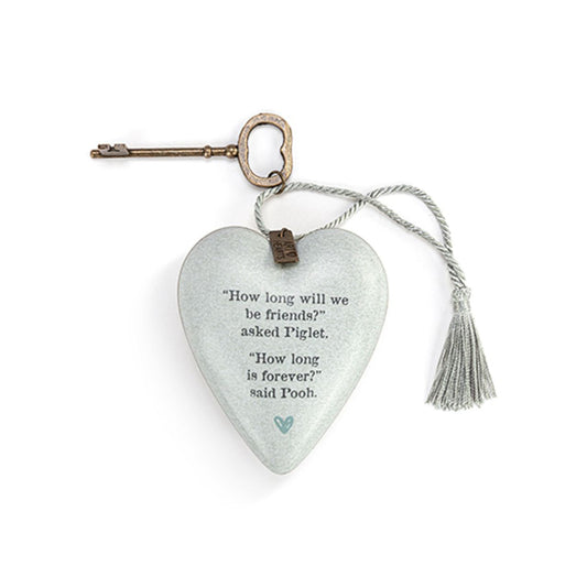 This heart-shaped ornament features a quote from Winnie the Pooh and Piglet about friendship's enduring power. Its simple yet striking design makes it a lovely gift for a treasured friend or loved one.