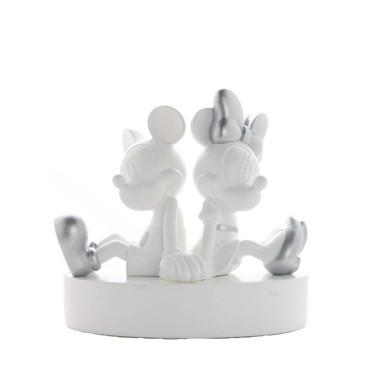 This substantial money box features the iconic pair holding hands back-to-back. This resin sculpture is a contemporary styled, statement figurine. The money slot is located at the back, with an easy-to-remove rubber plug on its base for retrieval of funds.