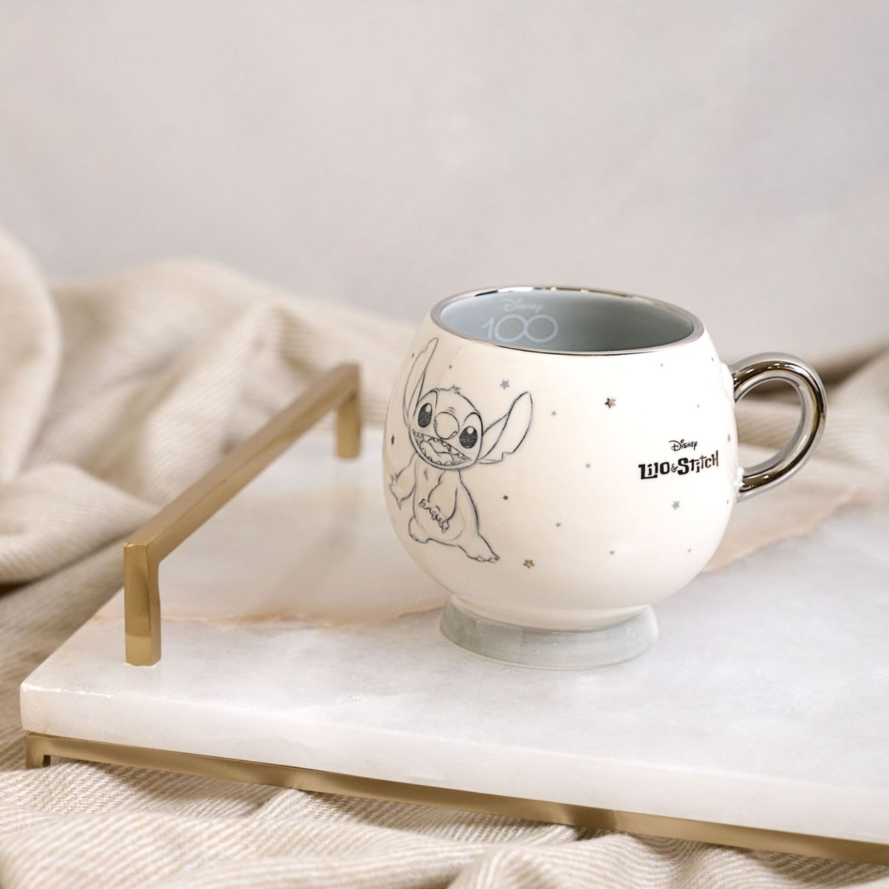 Disney 100th Anniversary Premium Mug - Stitch  A Stitch premium mug from Disney 100 by DISNEY.  This limited edition mug captures the true magic of Disney on its centenary and can be enjoyed by fans of all ages.