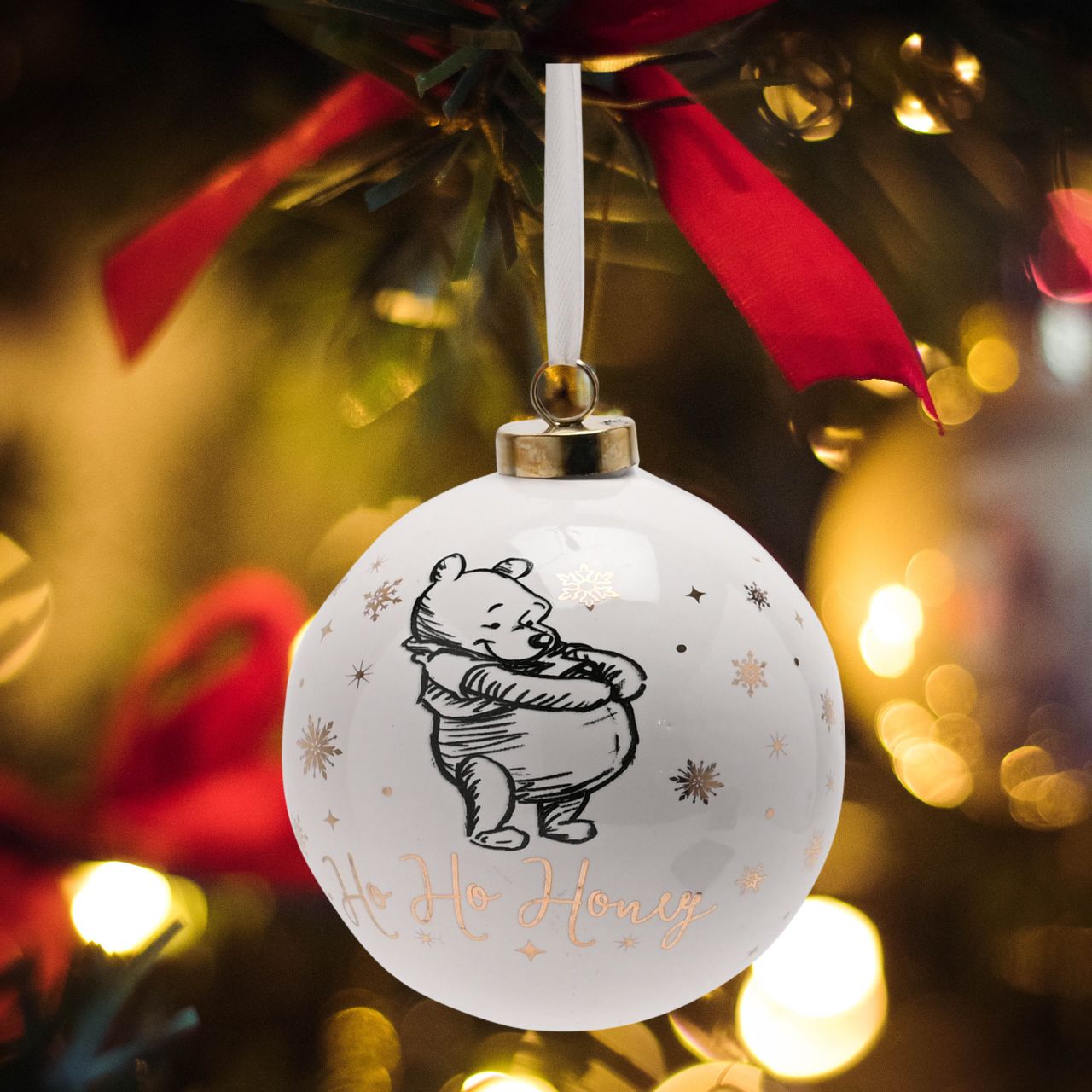 Disney Ceramic Christmas Bauble Winnie the Pooh  Bring touch of timeless Disney magic to the Christmas tree with this elegant gold foiled ceramic collectable Winnie the Pooh bauble. From Disney Classic Collectables - luxurious collectable gifts for the enduring Disney fan.