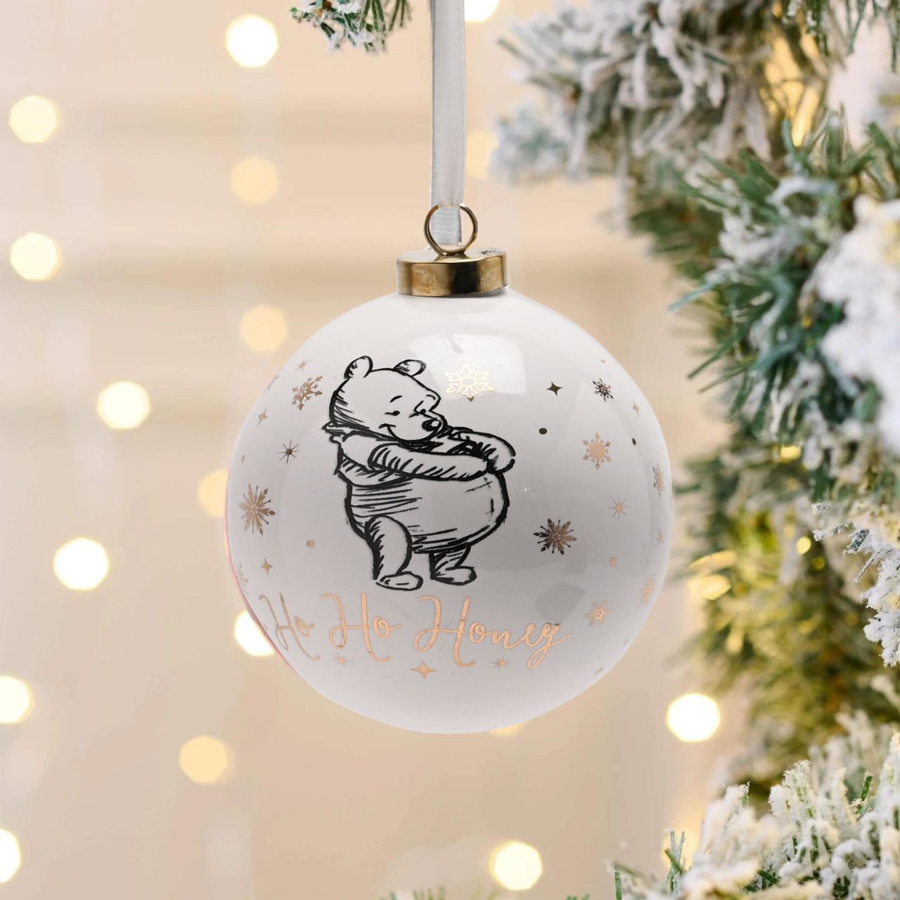 Disney Ceramic Christmas Bauble Winnie the Pooh  Bring touch of timeless Disney magic to the Christmas tree with this elegant gold foiled ceramic collectable Winnie the Pooh bauble. From Disney Classic Collectables - luxurious collectable gifts for the enduring Disney fan.