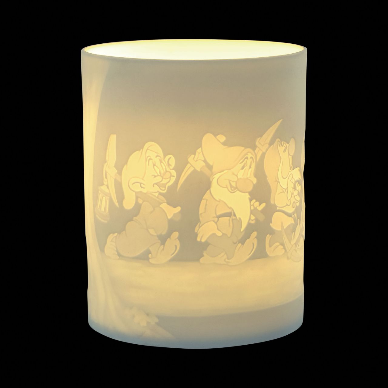 Snow White & The Seven Dwarfs Porcelain Tea Light Holder  The Seven Dwarfs will seem as if they are returning home from work when you light the LED candle and they flicker across your room creating a warm night light. The Seven Dwarf characters from Disney's Snow White are etched into the thin translucent porcelain.