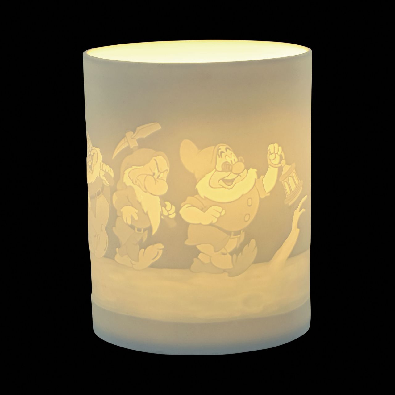 Snow White & The Seven Dwarfs Porcelain Tea Light Holder  The Seven Dwarfs will seem as if they are returning home from work when you light the LED candle and they flicker across your room creating a warm night light. The Seven Dwarf characters from Disney's Snow White are etched into the thin translucent porcelain.