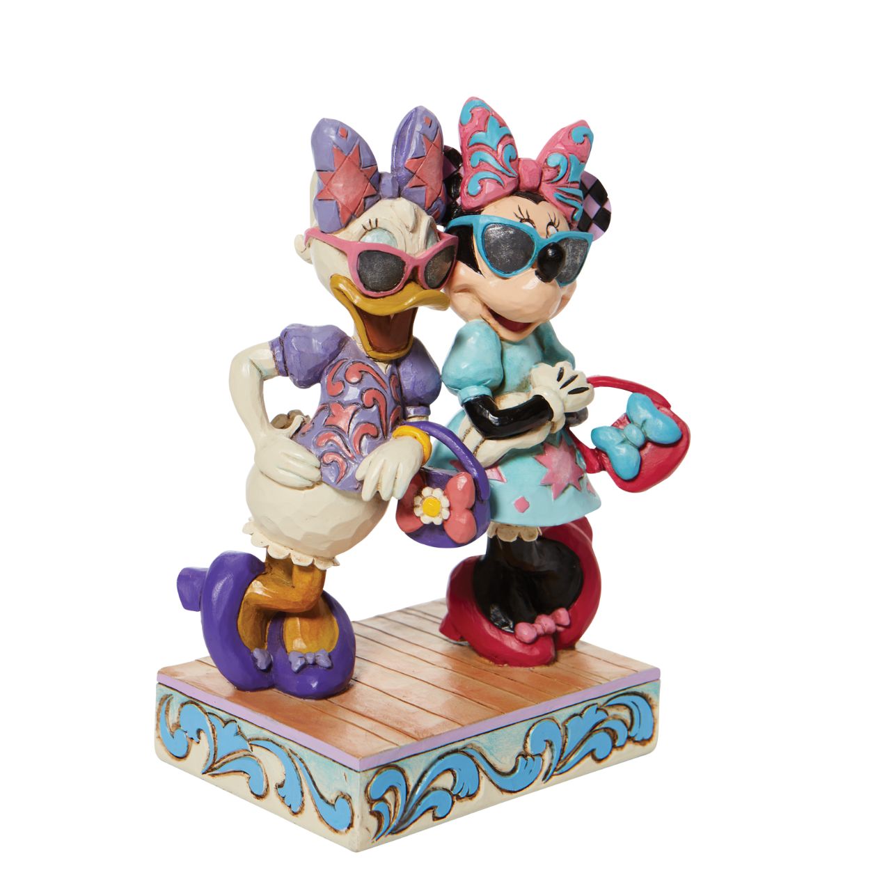 Disney "Fashionable Friends" Minnie and Daisy Figurine by Jim Shore  "Fashionable Friends" Mickey Mouse and Donald Duck would be nothing without their better and more fashionable halves! Minnie and Daisy don their finest duds to hit the town in style. Wearing shades, bows, matching purses and high heels, these ladies strike a power pose.
