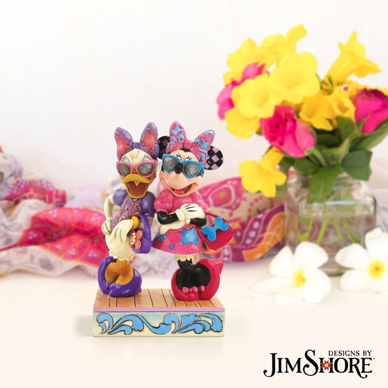 Disney "Fashionable Friends" Minnie and Daisy Figurine by Jim Shore  "Fashionable Friends" Mickey Mouse and Donald Duck would be nothing without their better and more fashionable halves! Minnie and Daisy don their finest duds to hit the town in style. Wearing shades, bows, matching purses and high heels, these ladies strike a power pose.