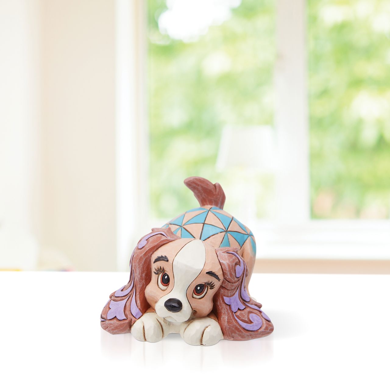 The Disney Traditions collection by Jim Shore brings you an enchanting upgrade of Lady from Lady and the Tramp| This mini animal figurine showcases Lady in a cute and instantly recognizable way, making it an absolutely irresistible addition to your collection.