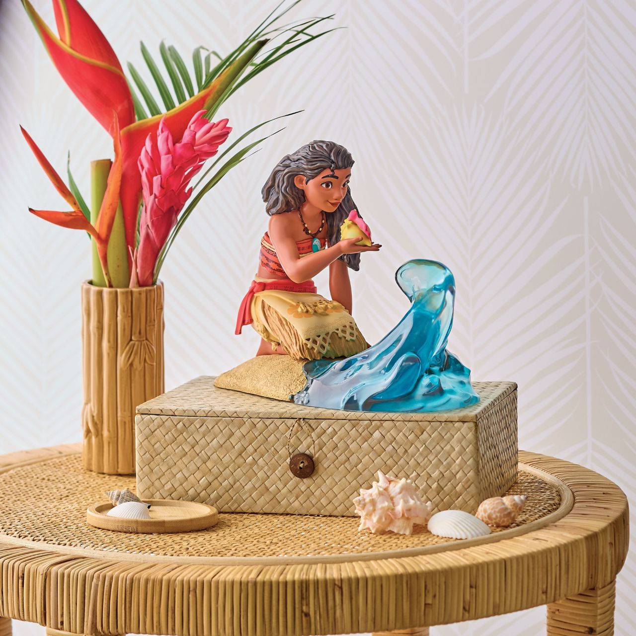 A clear resin wave swirls around Moana knees, creating a sense of motion and energy, reflecting her deep connection to the sea and her fearless spirit. Every detail is meticulously crafted, from Moana's traditional Polynesian attire to her confident expression and flowing hair.