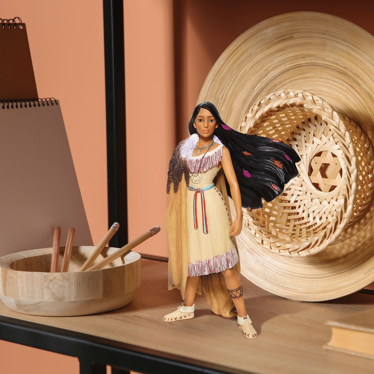 Pocahontas, daughter of Chief Powhatan of the Virginian native American tribe, strikes a powerful pose in this captivating Disney statuette. With colours in her hair and moccasins on her feet, she is a vision of beauty and female capability.