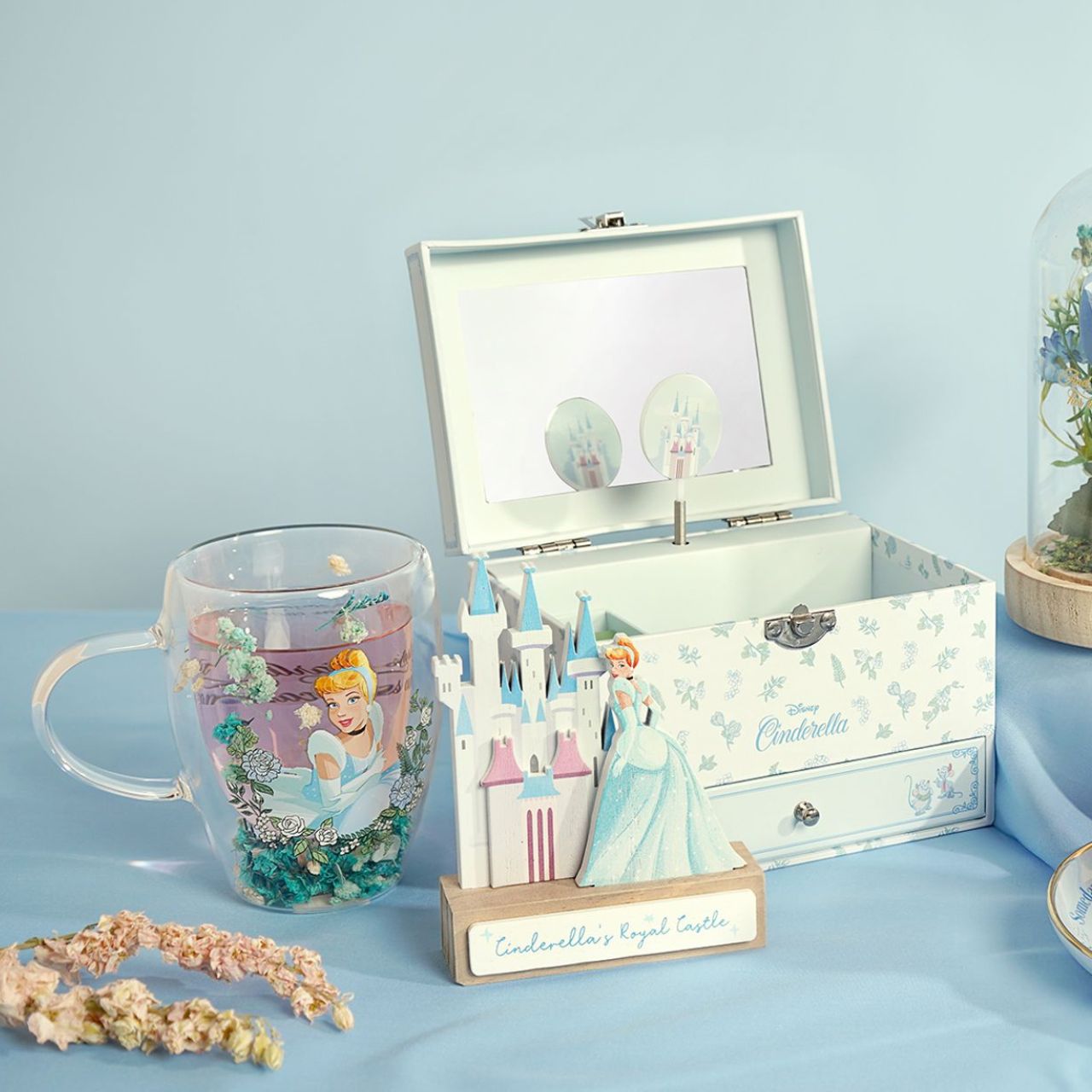 Step into the enchanting world of Disney with the Pastel Princess Glass Mug, adorned with a colourful illustration of Cinderella amidst a cascade of dried flowers.