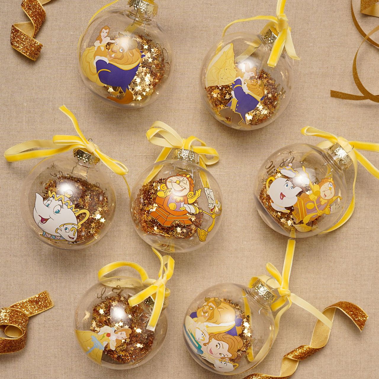 Make Christmas sparkle with this magical set of seven glass baubles featuring beloved characters from Disney's Beauty and the Beast. This set brings the enchanting tale to life with Belle, Beast, Lumiere, Mrs. Potts and others, adorning the delicate ornaments.