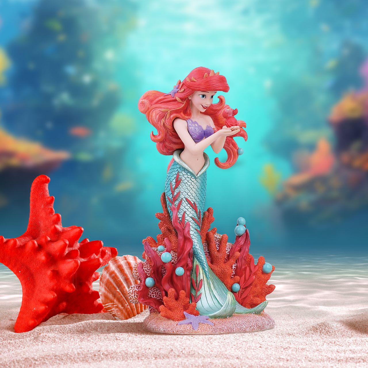 Ariel joins the Disney Showcase Botanical collection in honour of the film's 35th Anniversary featuring sea florals and coral (which is the 35th Anniversary gift). Ariel holds a small Sabastian in her delicate hands as she listens intently to his story. A vibrant base of coral, sand and rising bubbles encapsulates the underwater princess.