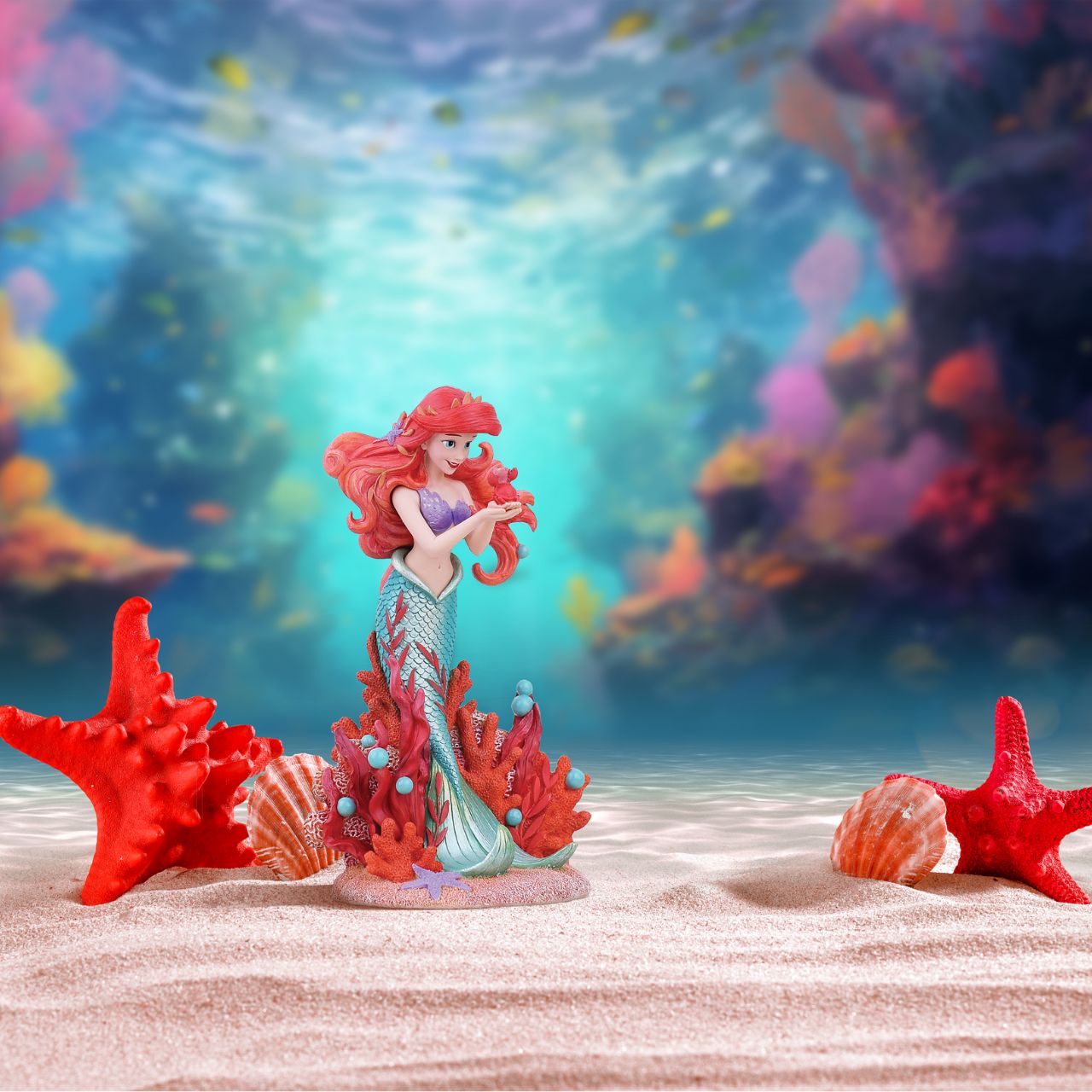 Ariel joins the Disney Showcase Botanical collection in honour of the film's 35th Anniversary featuring sea florals and coral (which is the 35th Anniversary gift). Ariel holds a small Sabastian in her delicate hands as she listens intently to his story. A vibrant base of coral, sand and rising bubbles encapsulates the underwater princess.
