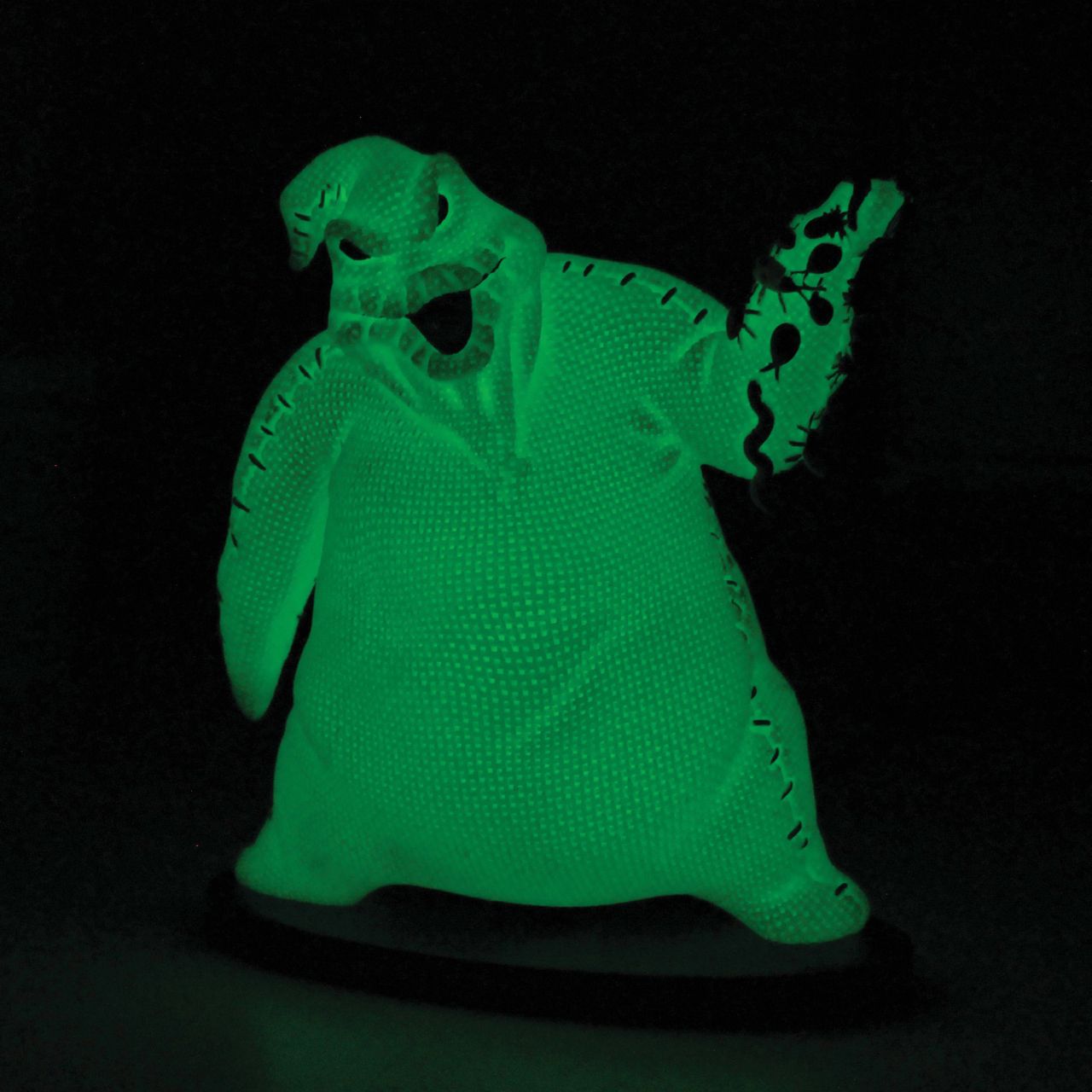 Imagine bringing home a piece of haunting magic with this Oogie Boogie glow-in-the-dark figurine. Every night will be full of delightful frights as Oogie Boogie, will let his ghostly glow add a touch of Halloween magic to your everyday.
