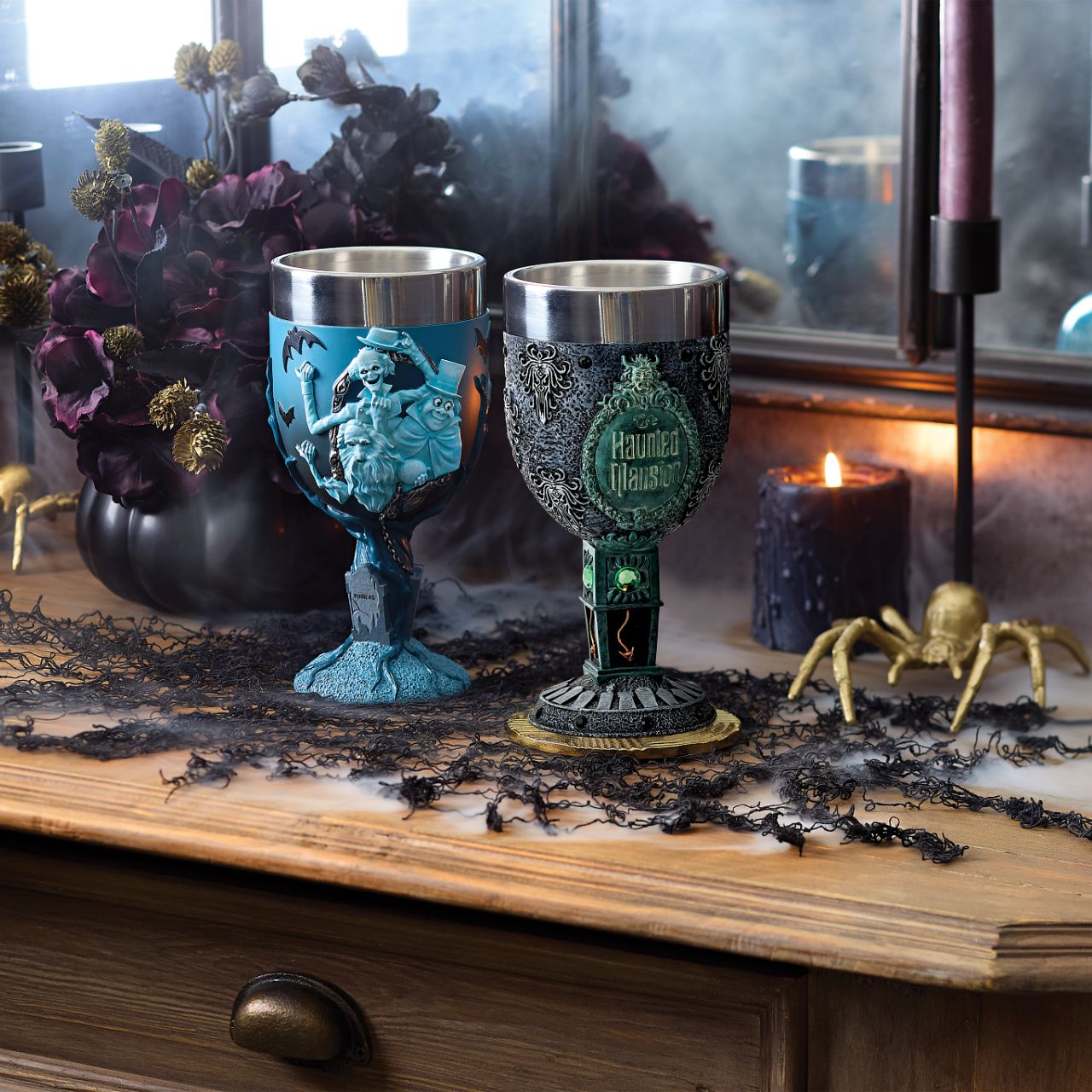 The Haunted Mansion Goblet is adorned with black gems around the top and the base, creating a beautifully spooky statement piece. It features a clock design on the stem, a bat on the body of the piece and gravestones wrapped around the base, all inspired by the iconic Haunted Mansion ride.