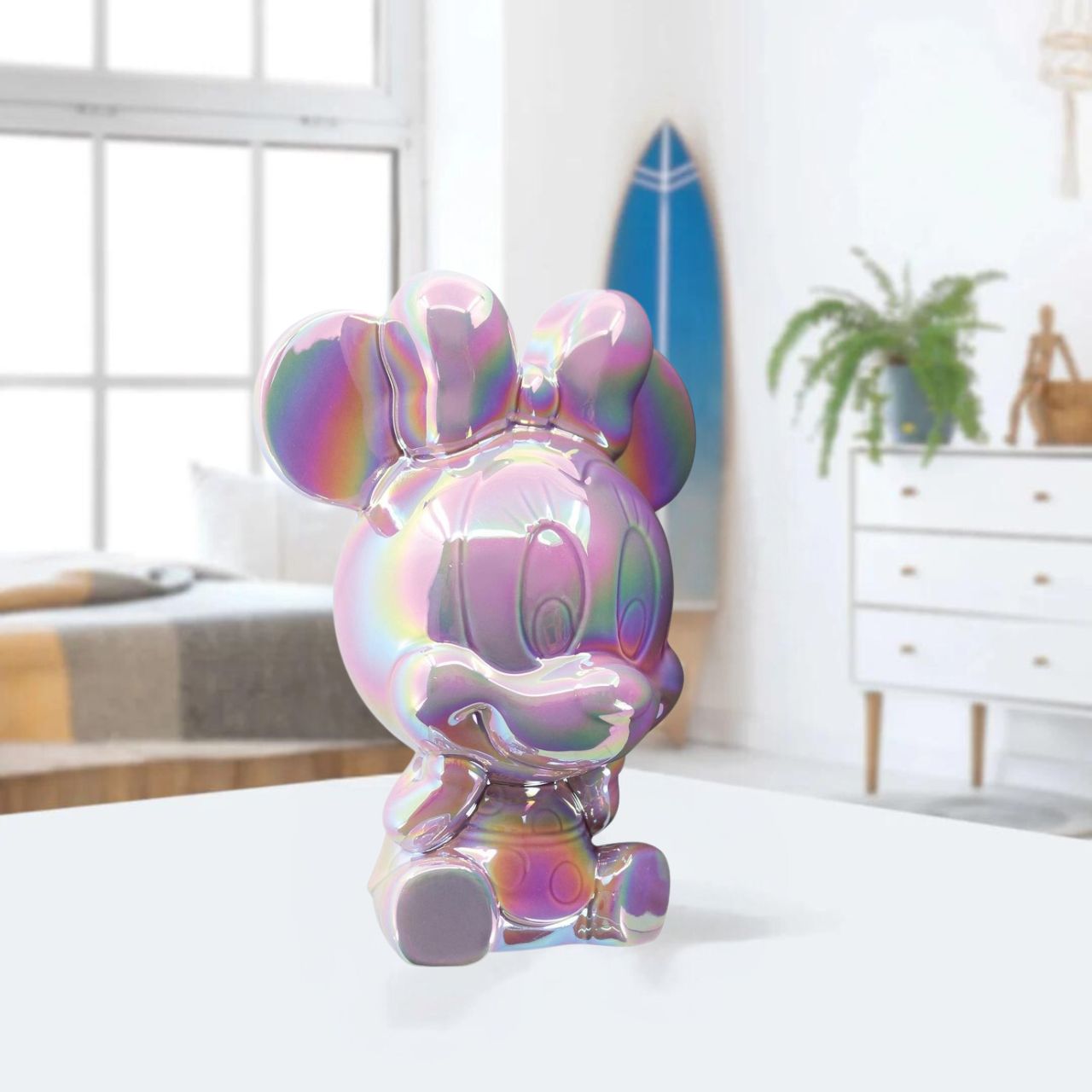 Make saving fun with the Minnie Ceramic Money Bank by Disney Showcase. It is the perfect, practical décor piece for Disney fans of all ages. At 18cm tall with a dazzling pink, iridescent finish this piece is guaranteed to catch the attention of all that see it and will add the Disney magic to any home.