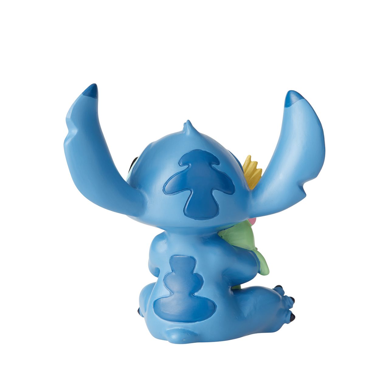 Disney Showcase Stitch Doll Figurine  Irresistibly adorable, this little Stitch will make you want to give your best friend the same tight squeeze he's giving his doll. 'Ohana means family, make him a part of yours.