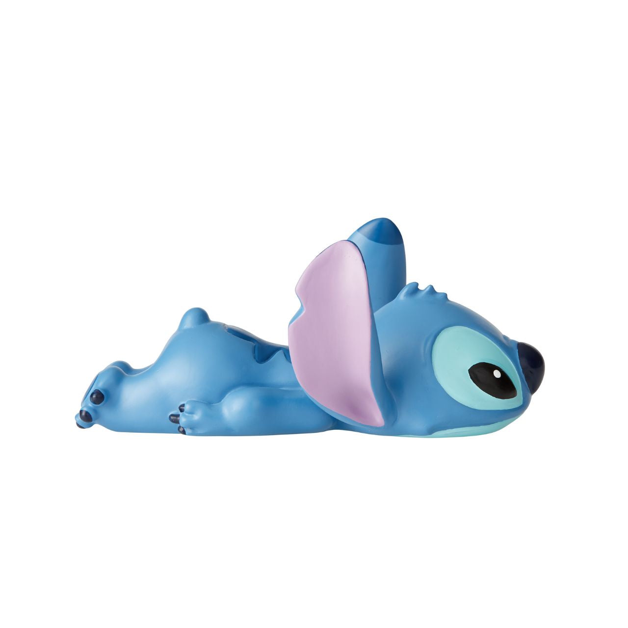 Stitch Laying Down Figurine by Disney Showcase  Stubborn Stitch is still as cute as ever, and this little guy can't help but make you smile. Cute, clever and charismatic, Stitch's fun-loving nature is just what you need to brighten your day.