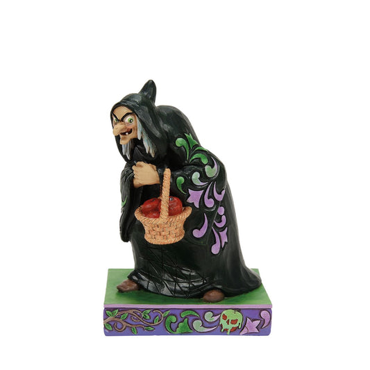 The original Disney villain, the Evil Queen in her disguise as The Hag in Snow White. Poised and ready to feed the fair Snow White the deadly apple, this is the perfect addition to any Disney collection.