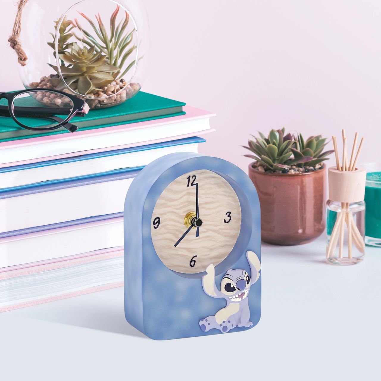 Tick-tock in Disney style. Introducing the Stitch Desk Clock-embossed with Stitch's charm on the front. This adorable timepiece brings playful energy to your workspace. Let Stitch keep you company as you navigate your day, adding a dash of Disney magic to every hour.
