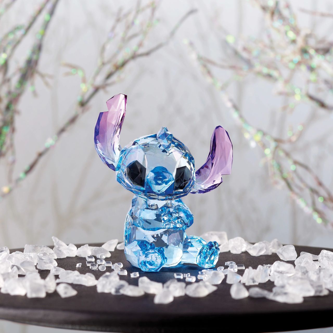 Disney Stitch Facets Figurine  This "gem cut" acrylic sculpture reflects Stitch's sparkling personality and childlike charm. Presented in a branded window gift box. Not a toy or children's product. Intended for adults only.