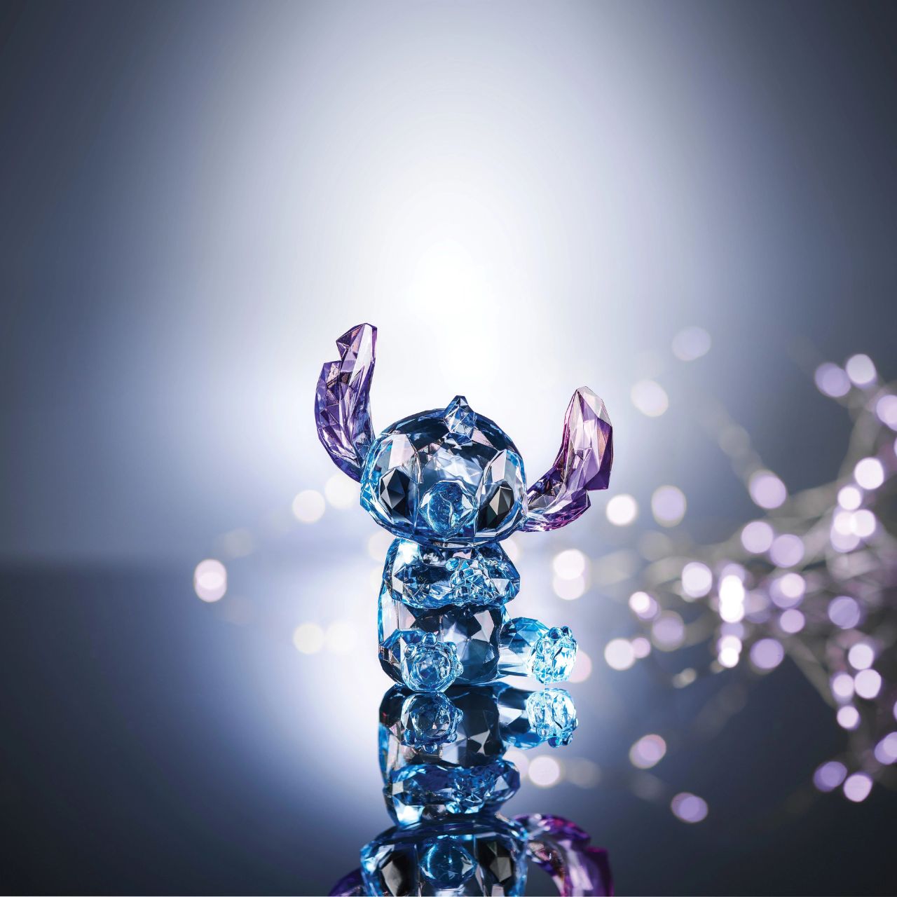 Disney Stitch Facets Figurine  This "gem cut" acrylic sculpture reflects Stitch's sparkling personality and childlike charm. Presented in a branded window gift box. Not a toy or children's product. Intended for adults only.